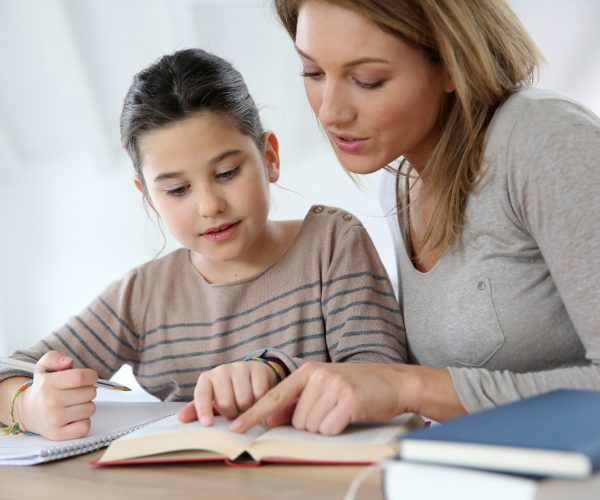 Lady helping daughter with homework sv oct 19